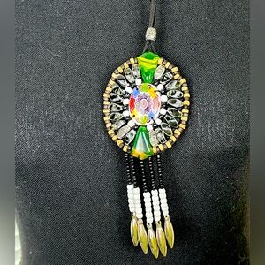 Beautiful boho style pendant of various stones mounted on leather.